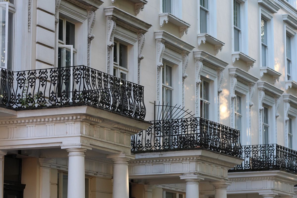 White stucco Georgian terrace with balconies in Prime Central London